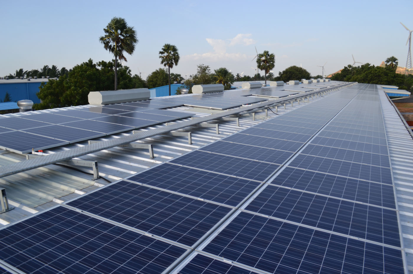 Solar panels across a large industrial warehouse rooftop